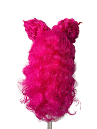 Bright hot pink curly wig with two small curled side pieces, displayed on a mannequin head against a plain light background.
